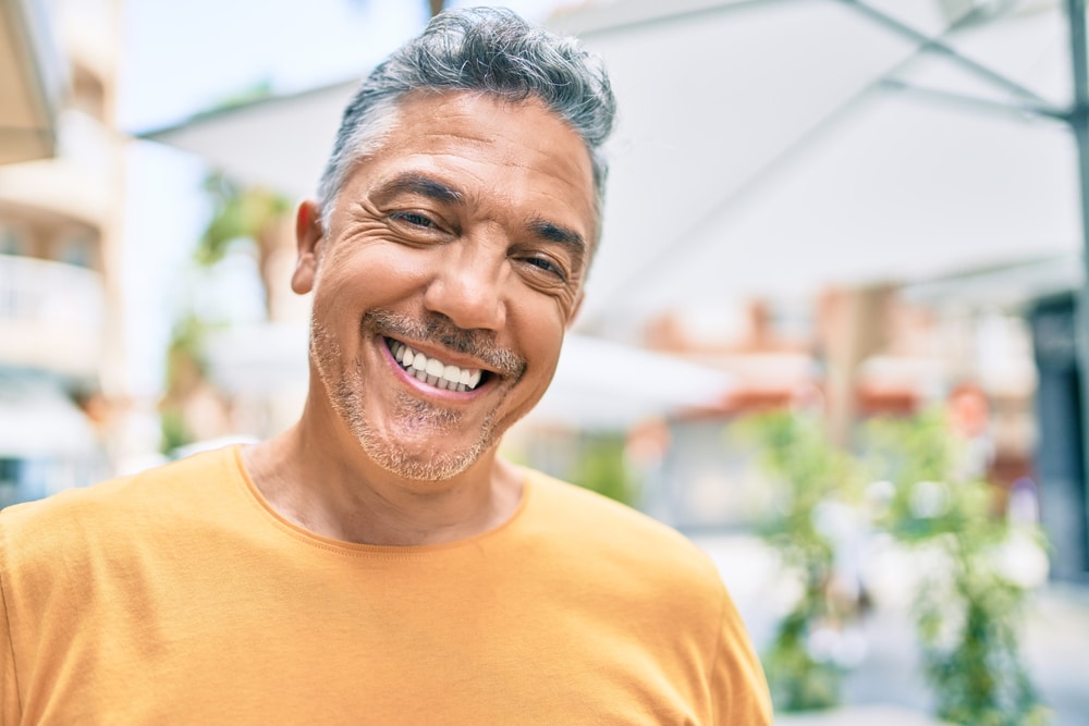 Man smiling after oral surgery in Nashville